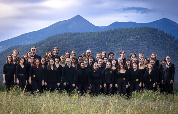 Shrine of the ages Choir in front of peaks standing in wildflowers